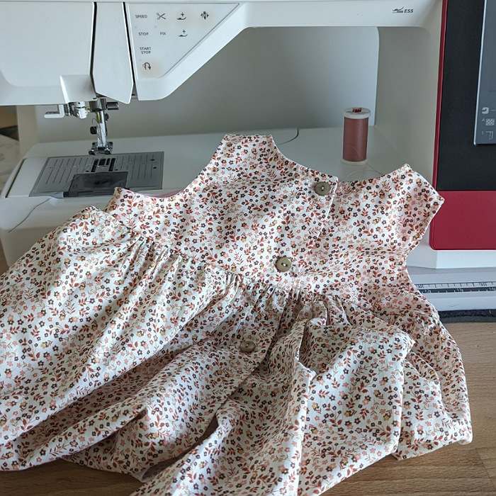 robe d'enfant posée sur une machine à coudre